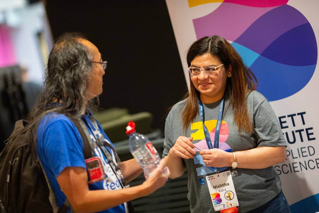 Nishtha chatting with an attendee at our booth.