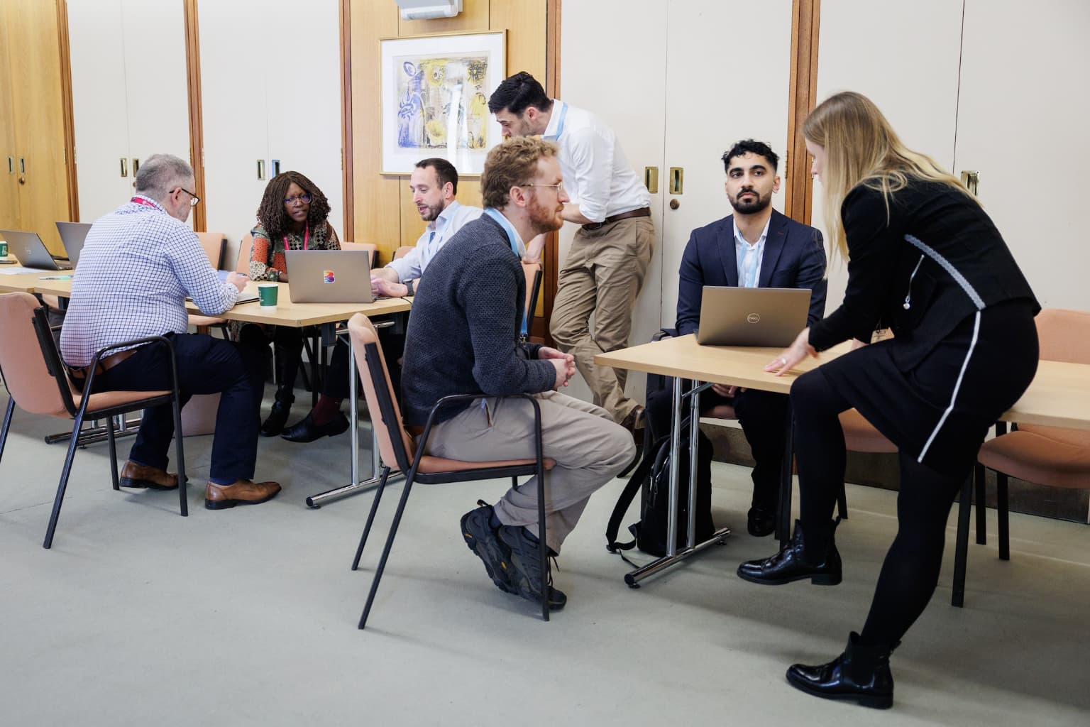 People sat around laptops discussing topics